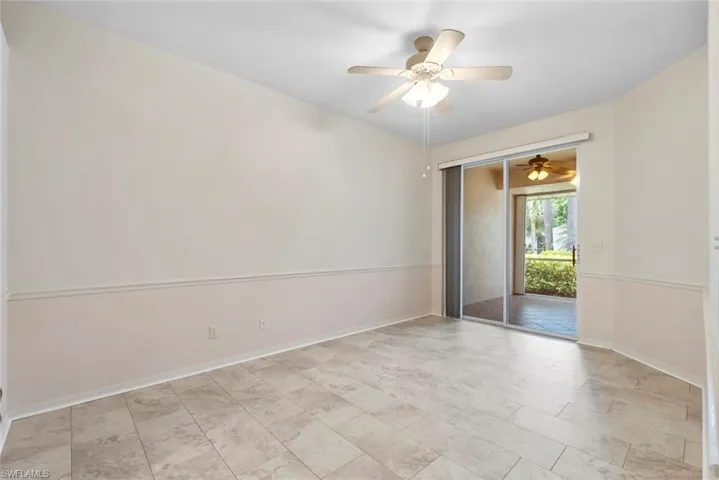 Spare room with baseboards and a ceiling fan