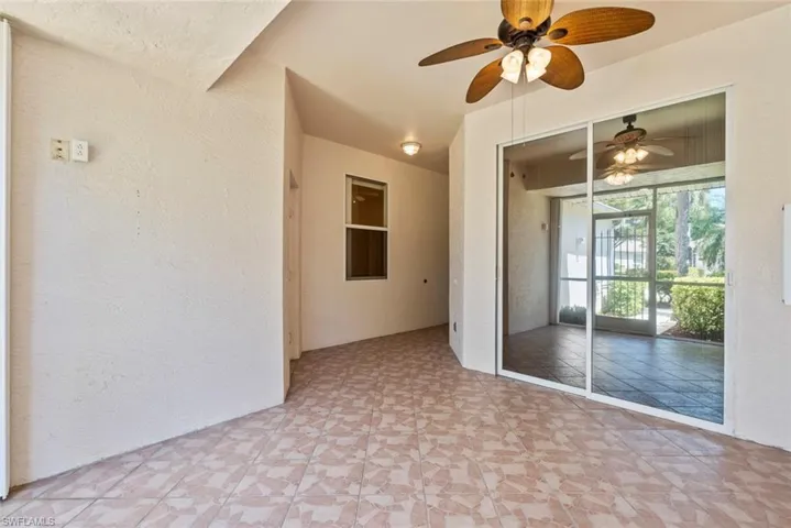 View of screened in lanai with ceiling fan and sliders leading to Primary Bedroom