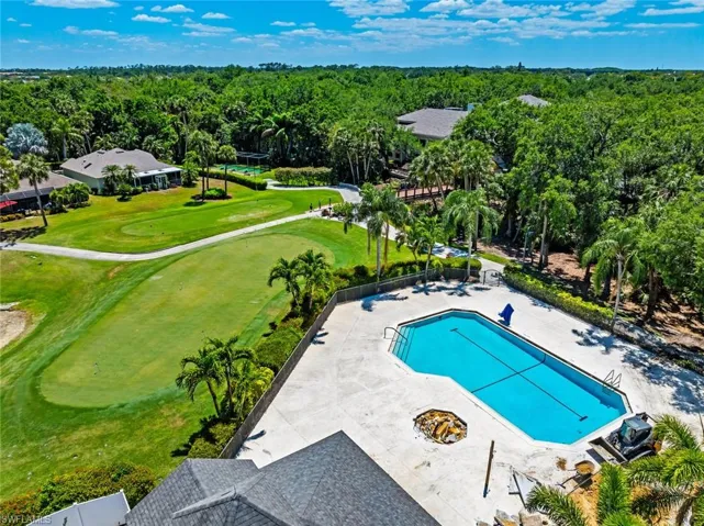 Bird's eye view featuring a wooded view and golf course view