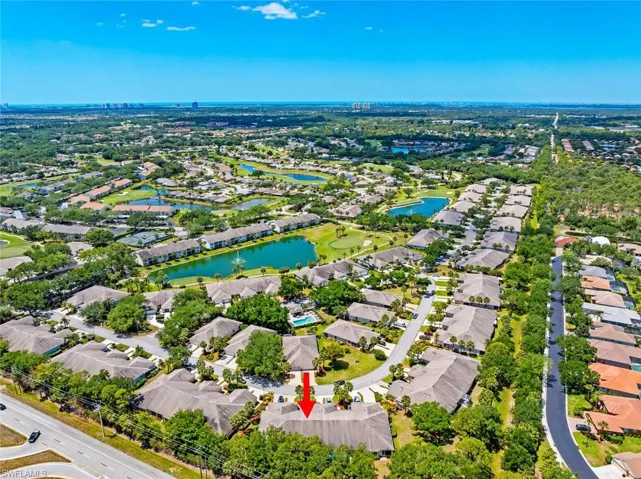 Birds eye view of property featuring a water view and a residential view