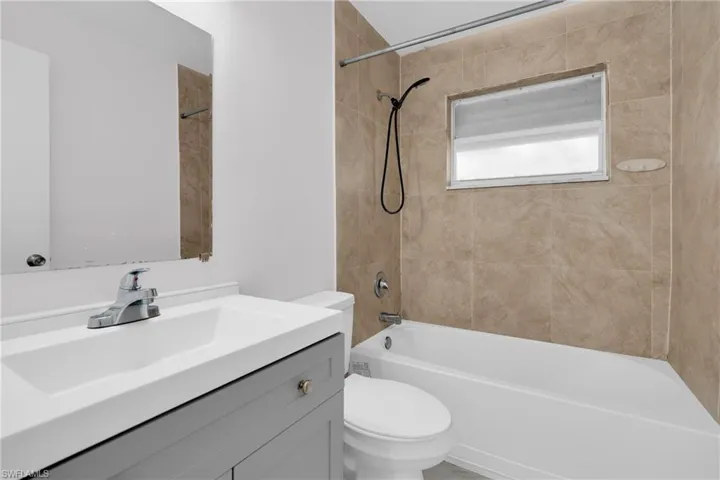 Bathroom with vanity and bathing tub / shower combination