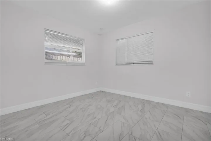 Unfurnished room with baseboards