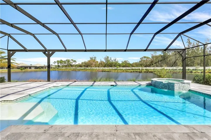 View of pool with a lanai, a water view, and a sunroom