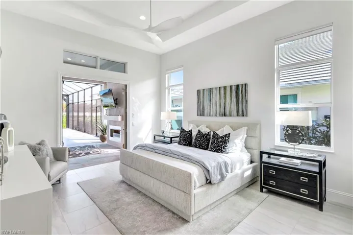 Bedroom featuring access to outside, recessed lighting, and a tray ceiling