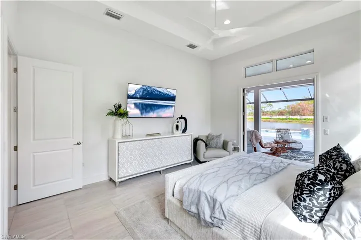 Bedroom featuring recessed lighting, access to outside, a sunroom, and light tile patterned floors