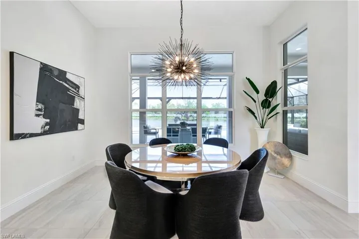 Dining area featuring baseboards and a chandelier