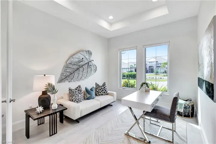 Office space with recessed lighting, a raised ceiling, and light tile patterned floors