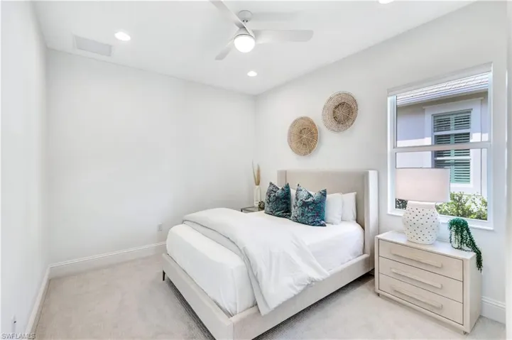 Bedroom featuring light colored carpet, a ceiling fan, and recessed lighting
