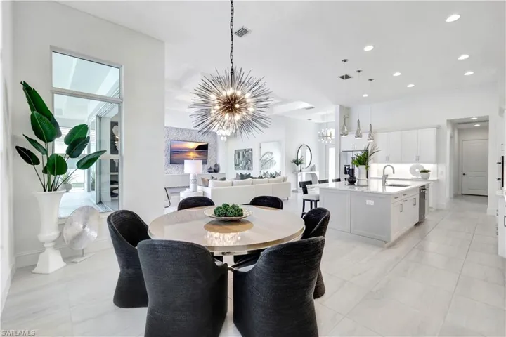Dining room with recessed lighting and a chandelier