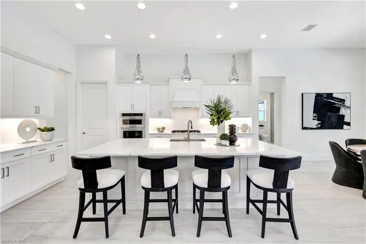 Dining area featuring baseboards and a chandelier