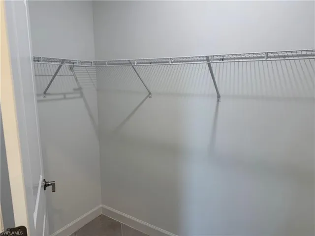 View of primary bedroom walk-in closet