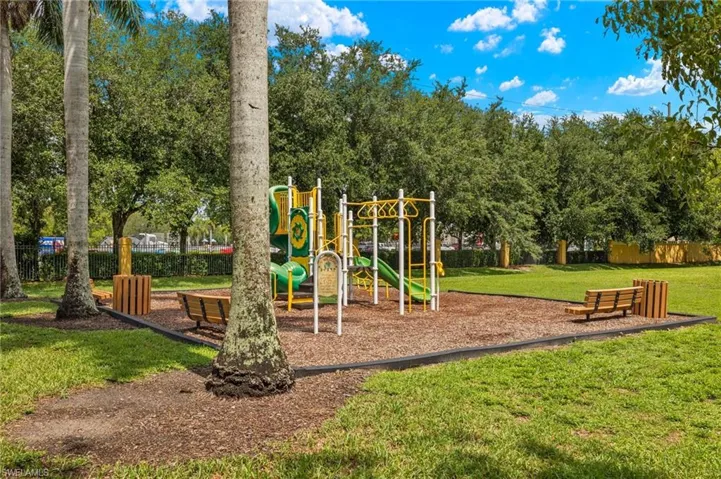 View of community playground with along with a BBQ area