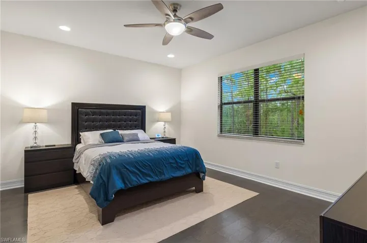 Large Owner bedroom featuring wood flooring and ceiling fan.