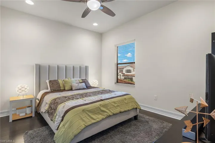 Bedroom three featuring, walk in closet, dark hardwood flooring and ceiling fan