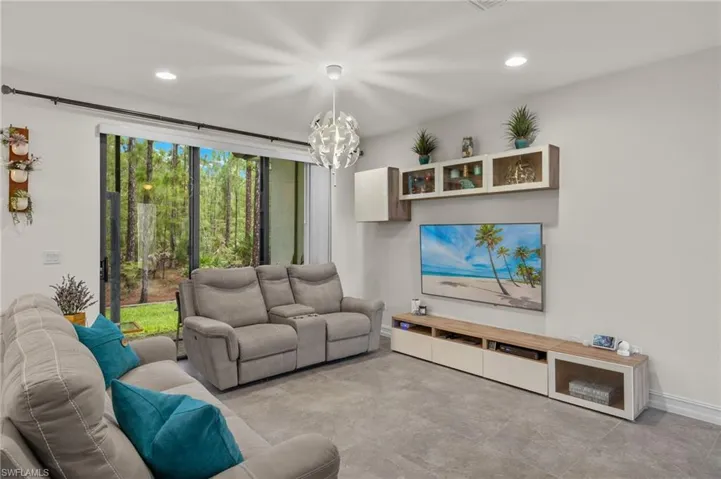 Living room with a quiet view of preserve from lanai