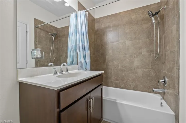 Guest Bathroom featuring tub/shower, tile flooring