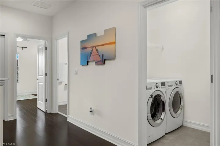 Full Guest Bath, conveniently located laundry room with tile flooring, sink, washer and dryer