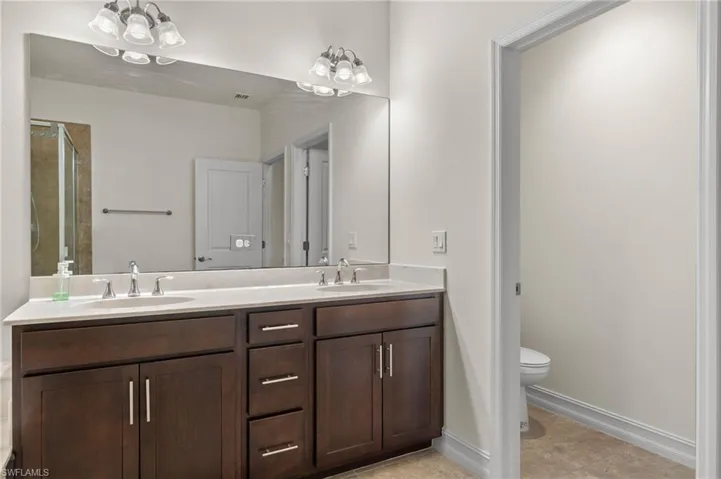 Owners Ensuite Bathroom with tile flooring, oversized vanity with dual sinks