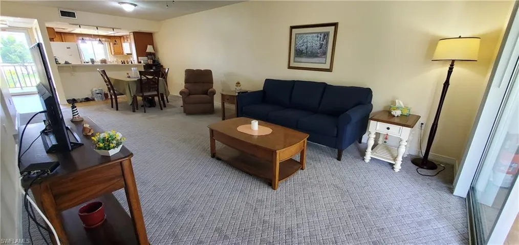 Carpeted living room with baseboards