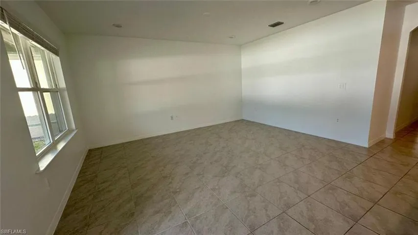 Spare room featuring baseboards
