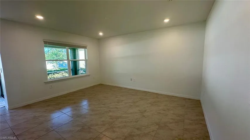 Spare room with recessed lighting and baseboards