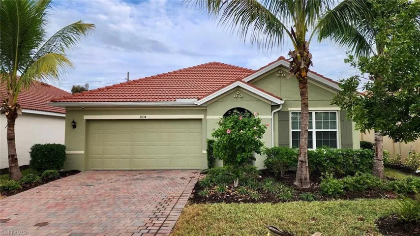 Single story home featuring stucco siding, decorative driveway, a tiled roof, and a garage