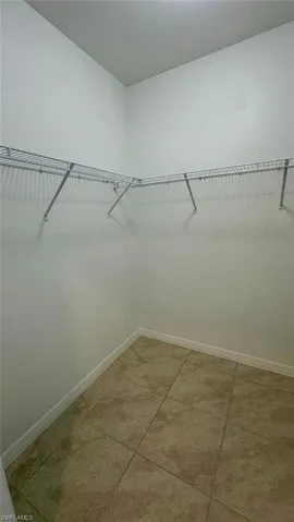 Walk in closet featuring light tile patterned flooring