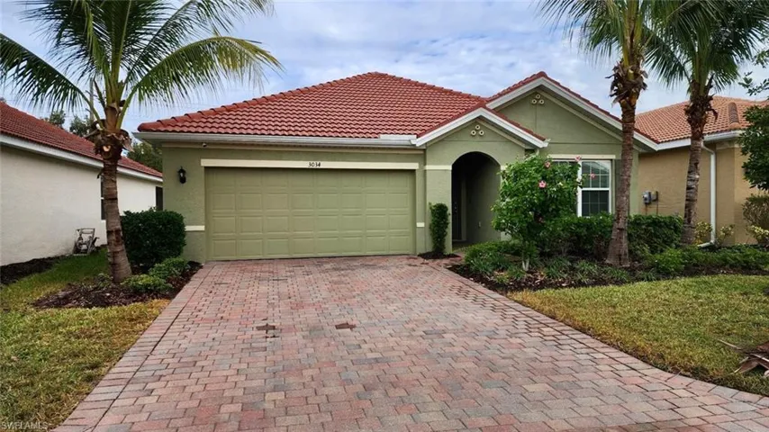 View of front of property with stucco siding, decorative driveway, a garage, and a tile roof