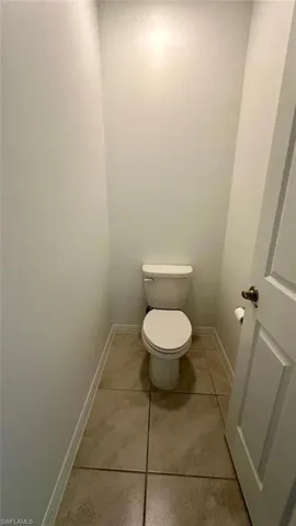 Bathroom featuring baseboards and light tile patterned flooring