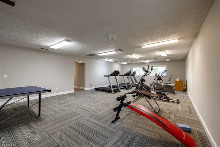 Workout area featuring a textured ceiling