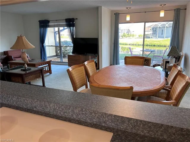 Dining space featuring carpet floors and a textured ceiling