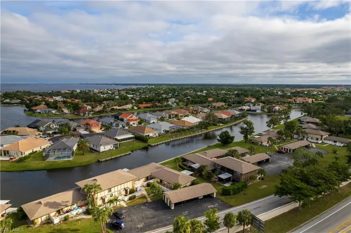Birds eye view of property with a water view