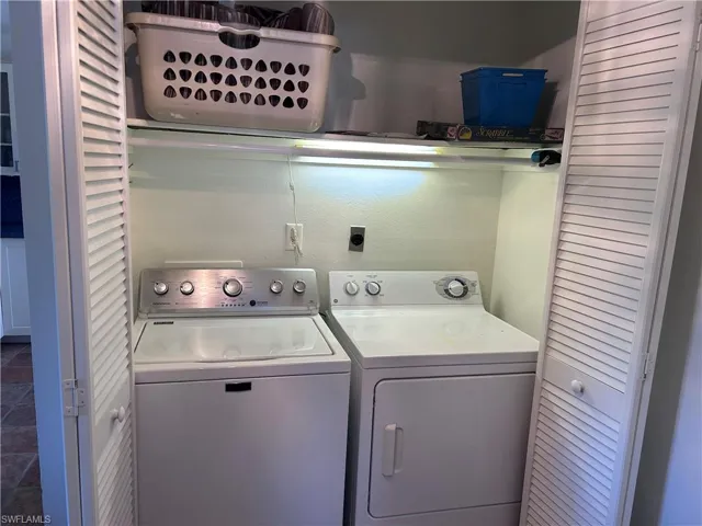 Clothes washing area featuring washing machine and clothes dryer