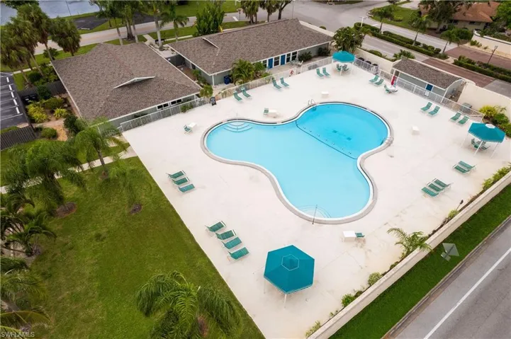 View of pool with a patio and a lawn