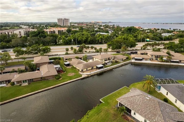 Birds eye view of property with a water view