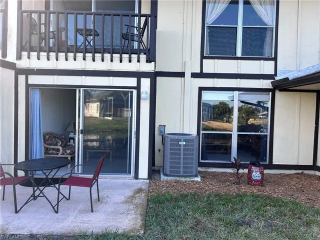 View of exterior entry featuring a balcony and central air condition unit