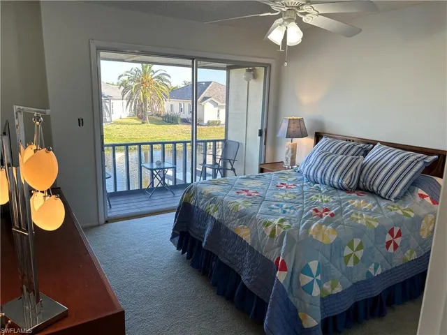 Bedroom with access to outside, ceiling fan, and carpet
