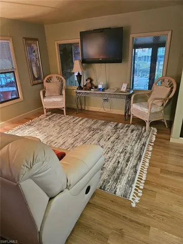 Living room featuring laminate wood look floors