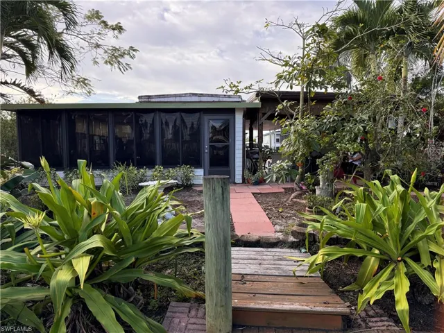 Back of property featuring a sunroom