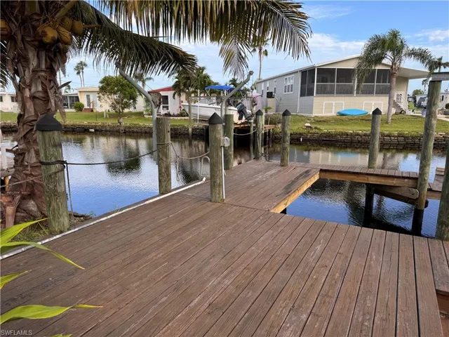 View of dock featuring a water view and a yard