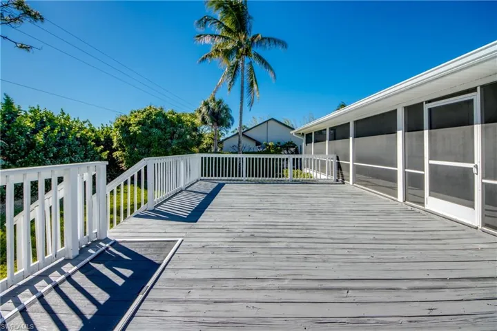 Wooden deck featuring a sunroom