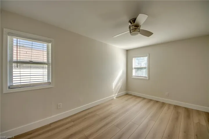 Spare room with light wood-style floors and ceiling fan