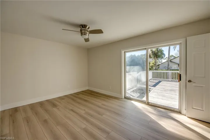 Empty room featuring light wood-style flooring and ceiling fan