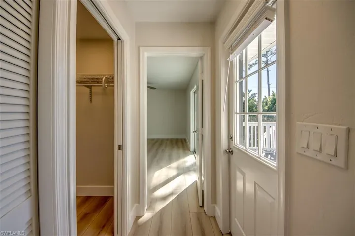 Corridor with light wood finished floors and baseboards