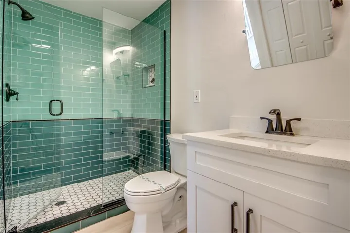 Full bath featuring vanity and a stall shower