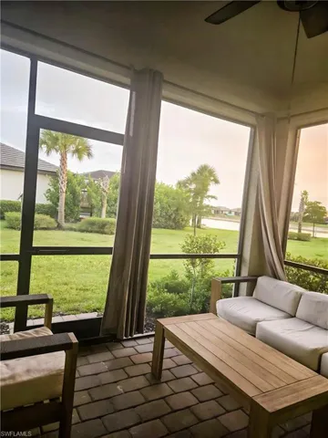 Sunroom featuring a ceiling fan and outdoor lounge area