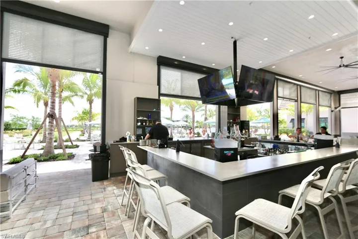 Kitchen featuring stone tile flooring, recessed lighting, a high ceiling, and a ceiling fan