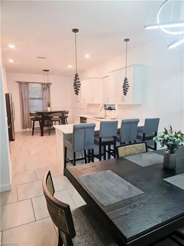 Dining area featuring light tile patterned flooring and recessed lighting