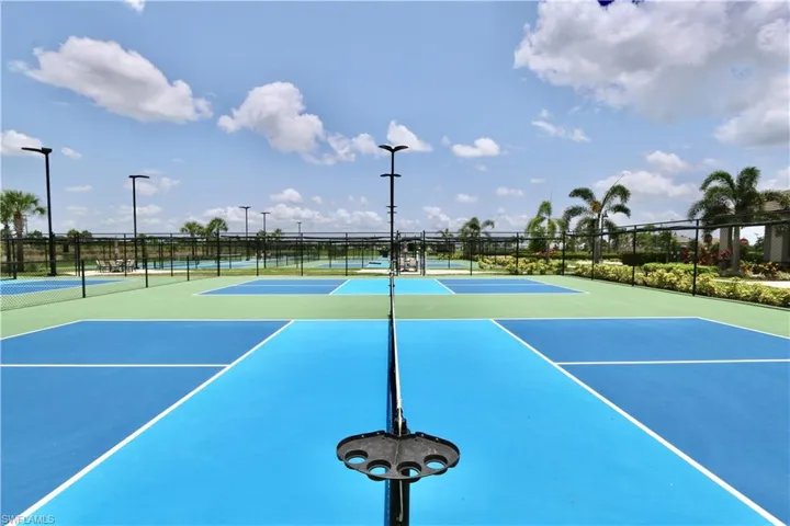 View of tennis court with community basketball court