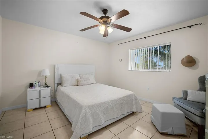 Bedroom featuring light tile patterned floors and ceiling fan